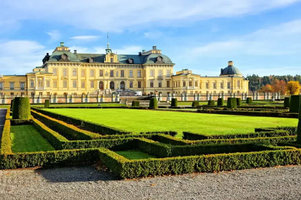 View of the majestic Drottningholm Palace from the perfectly manicured gardens on a sunny day in Stockholm, Sweden.