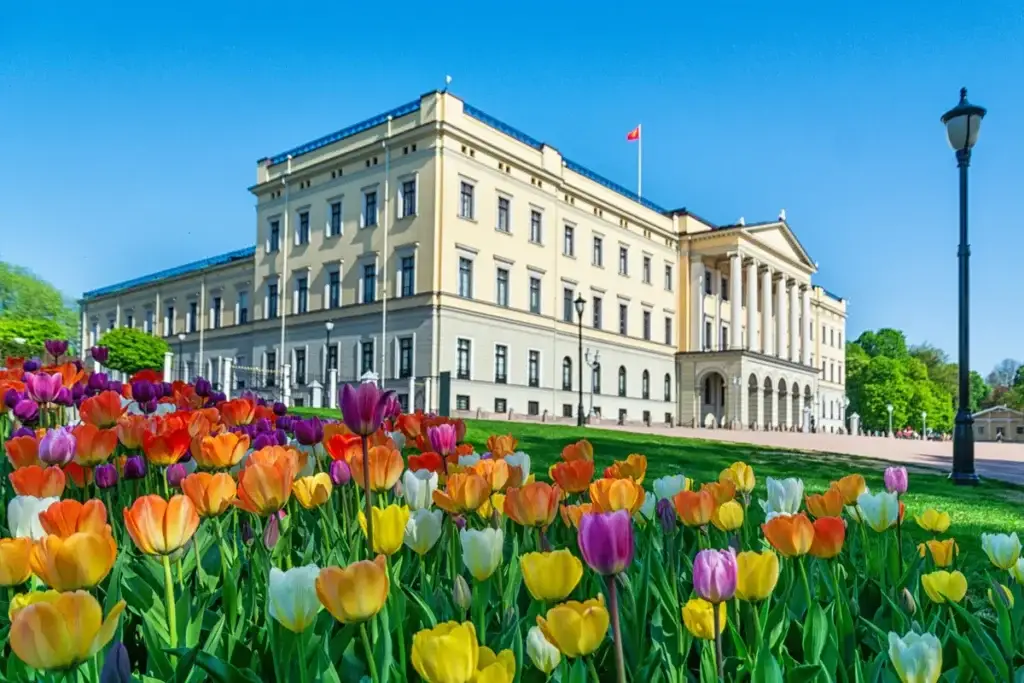 Royal Palace in Oslo surrounded by vibrant tulips, a prime attraction for visitors on Scandinavia Private Tours.
