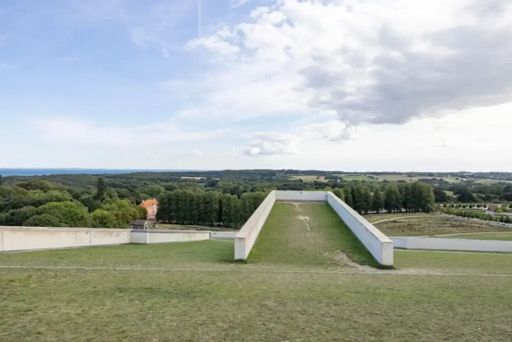 Aerial view of Moesgaard Museum with lush green landscape and architectural surrounds in Aarhus, Denmark, showcasing Scandinavian culture and history.