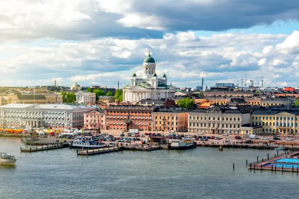 Panoramic view of Helsinki cityscape with Helsinki Cathedral and bustling market square by the waterfront in Finland.