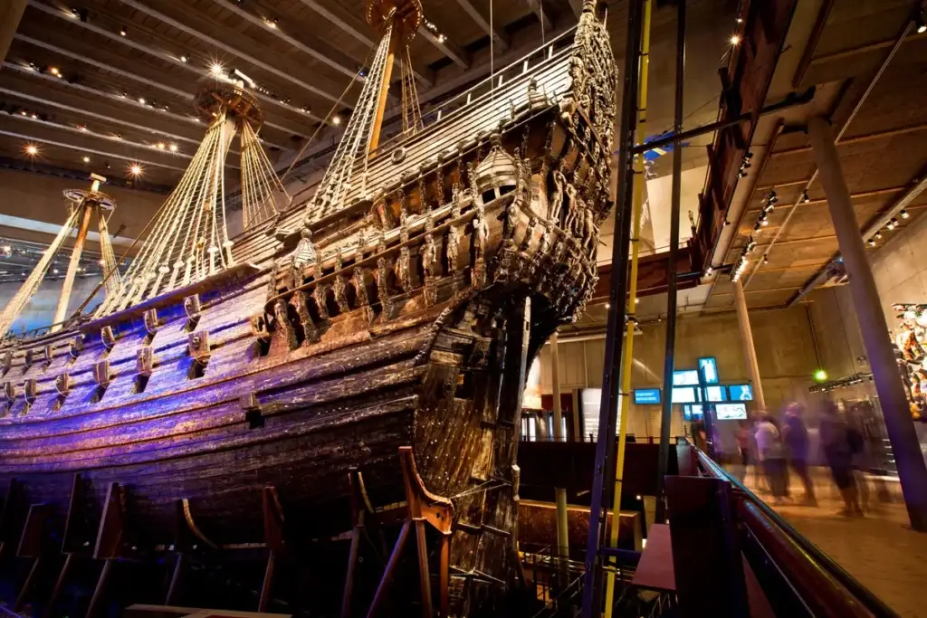 Impressive display of the Vasa ship at the Vasa Museum in Stockholm, Sweden, showcasing the well-preserved maritime vessel with intricate wooden carvings under dramatic lighting.