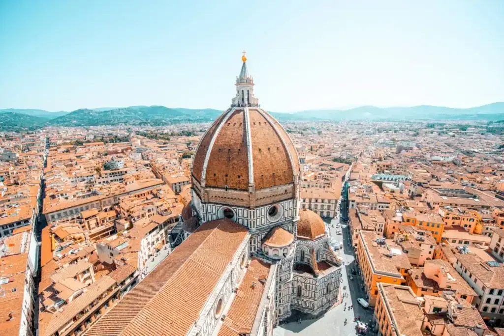 Aerial view of Florence Cathedral with its iconic red dome and surrounding historic cityscape in Florence, Italy, highlighting European architecture and cultural heritage.