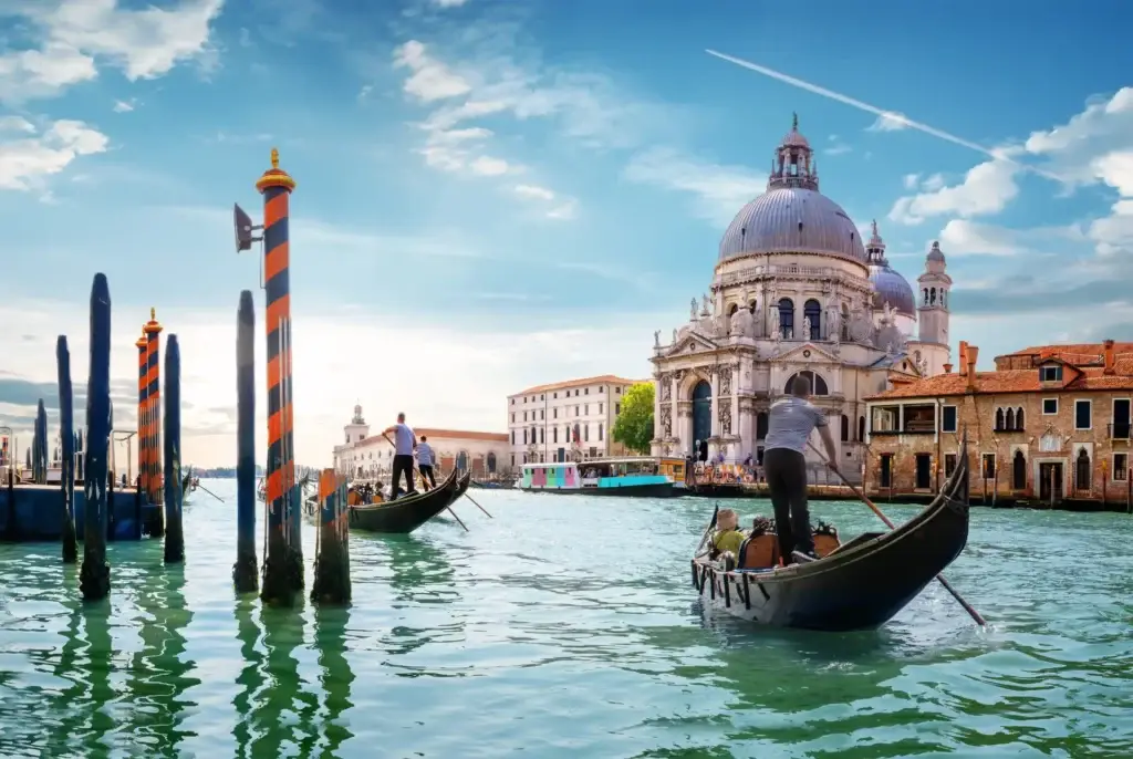 Gondola navigating the Grand Canal with the iconic Basilica di Santa Maria della Salute in the background, Venice, Italy