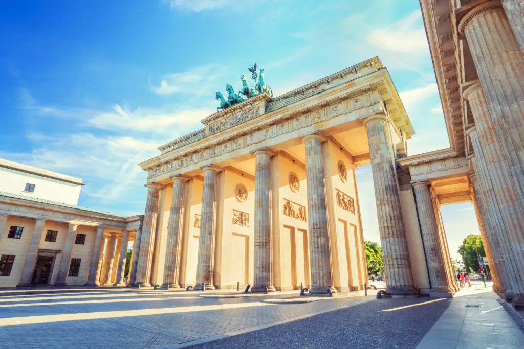 Brandenburg Gate in Berlin Germany under bright blue sky, historic landmark and popular tourist attraction in Europe