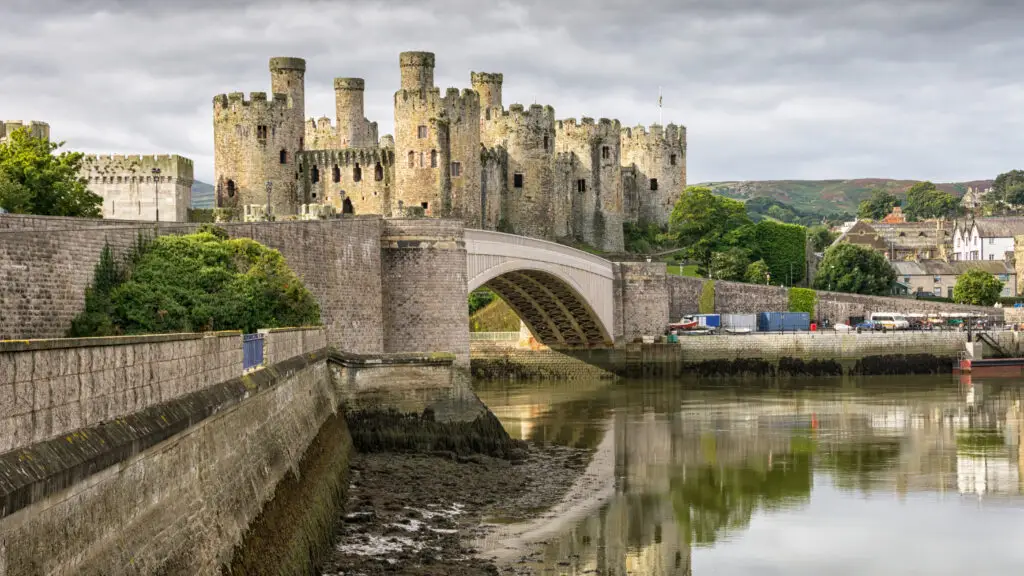 Historic Conwy Castle and bridge reflected in the River Conwy, Wales, showcasing medieval architecture and scenic landscape for European private tours
