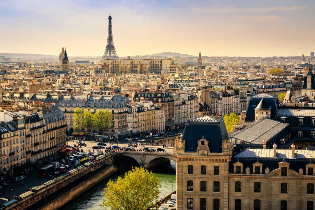 Panoramic view of Paris cityscape with the Eiffel Tower, Seine River, and classic Parisian architecture in France, highlighting top attractions for Europe private tours.