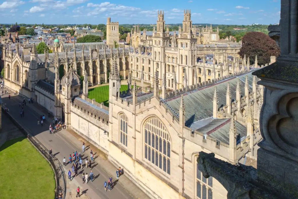 Aerial view of historic university buildings and tourists exploring Oxford city center in Oxford, England