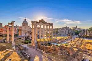 Ancient ruins of the Roman Forum in Rome Italy with historic temples and columns at sunset showcasing one of the top tourist attractions in Europe