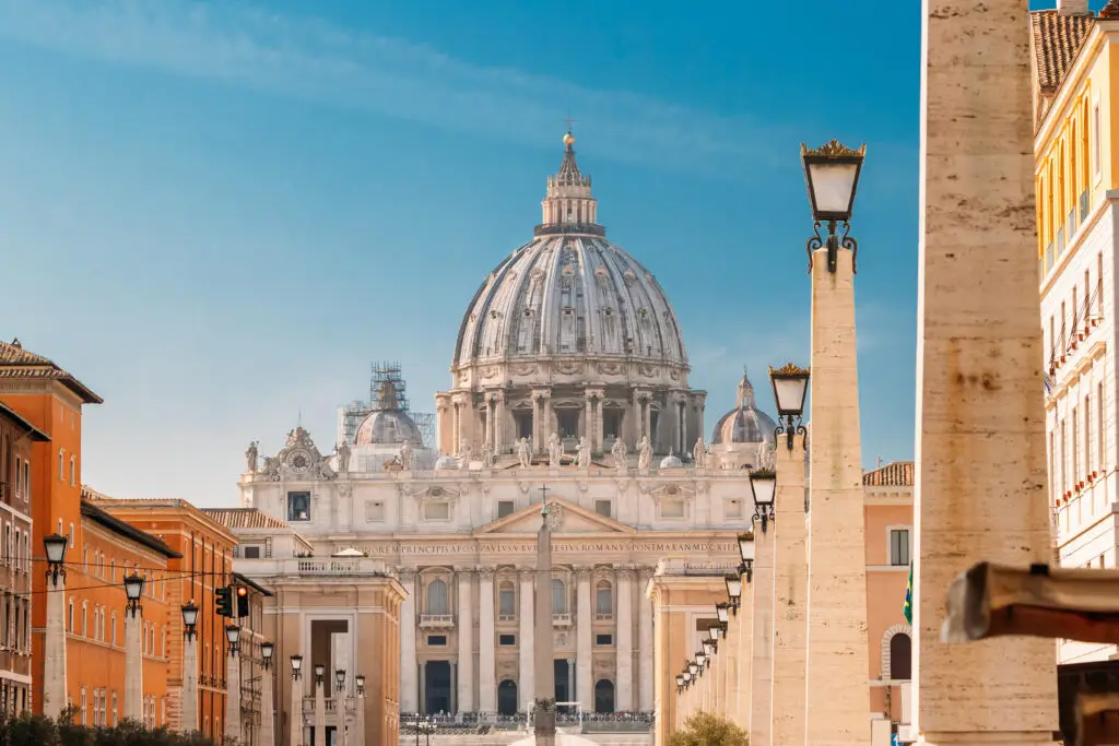 St. Peter's Basilica and St. Peter's Square in Vatican City with classic architecture and blue sky, popular tourist attraction on European private tours