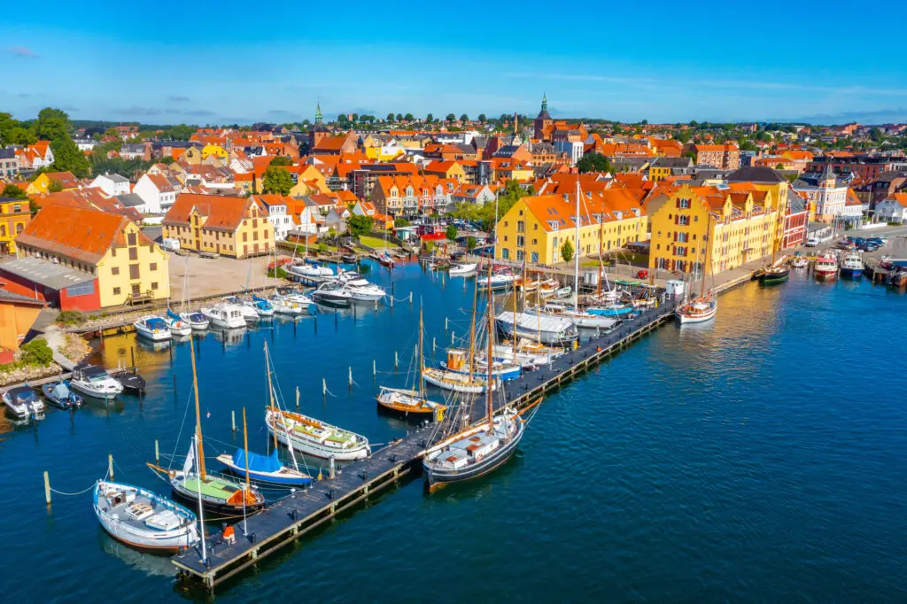 Colorful harbor with sailboats and traditional Danish houses in Svendborg, Denmark, a picturesque coastal town popular for private tours and seaside tourism in Southern Funen