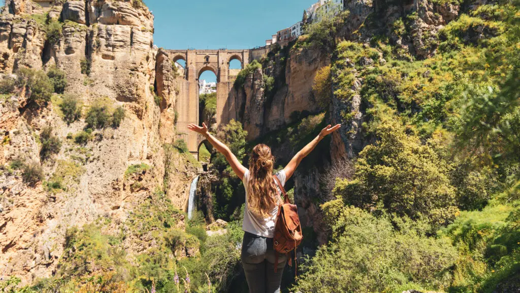 Traveler admiring Puente Nuevo bridge and canyon views in Ronda Spain during a scenic private tour