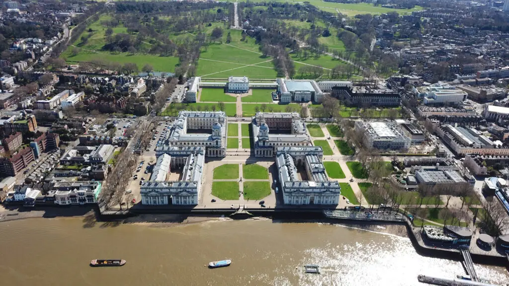 Aerial drone view of the Old Royal Naval College and Greenwich Park in London, England, showcasing historic architecture and the River Thames, popular sightseeing destination for Europe private tours