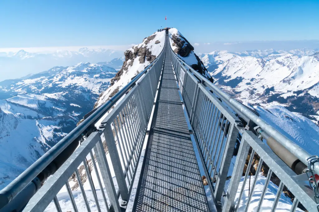 Titlis Cliff Walk suspension bridge in Engelberg, Switzerland, offering panoramic views of the snow-covered Swiss Alps