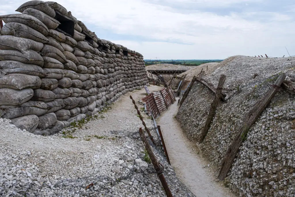 World War I trench battlefield in Verdun France with preserved sandbag walls and defensive structures