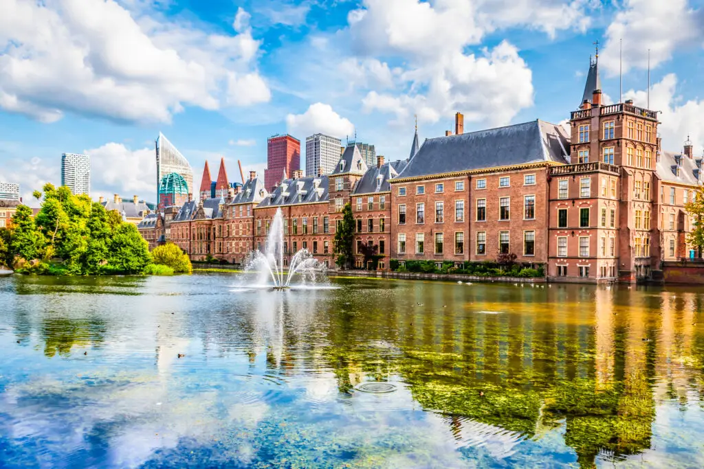 Dutch Parliament building in The Hague, The Netherlands with scenic pond and fountain on a sunny day, popular tourist attraction in Holland