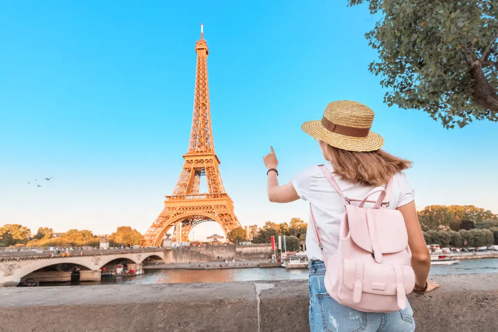 Tourist admiring the Eiffel Tower in Paris France during a private sightseeing tour along the Seine River