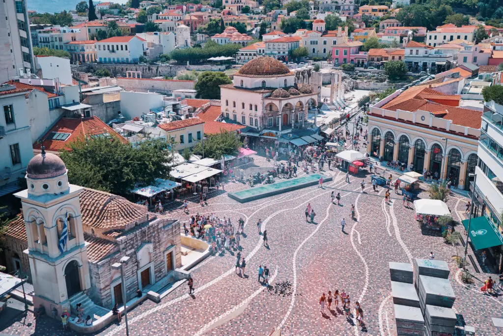 Aerial view of Monastiraki Square in Athens, Greece showing historic architecture, vibrant market stalls, and tourists exploring this popular travel destination.