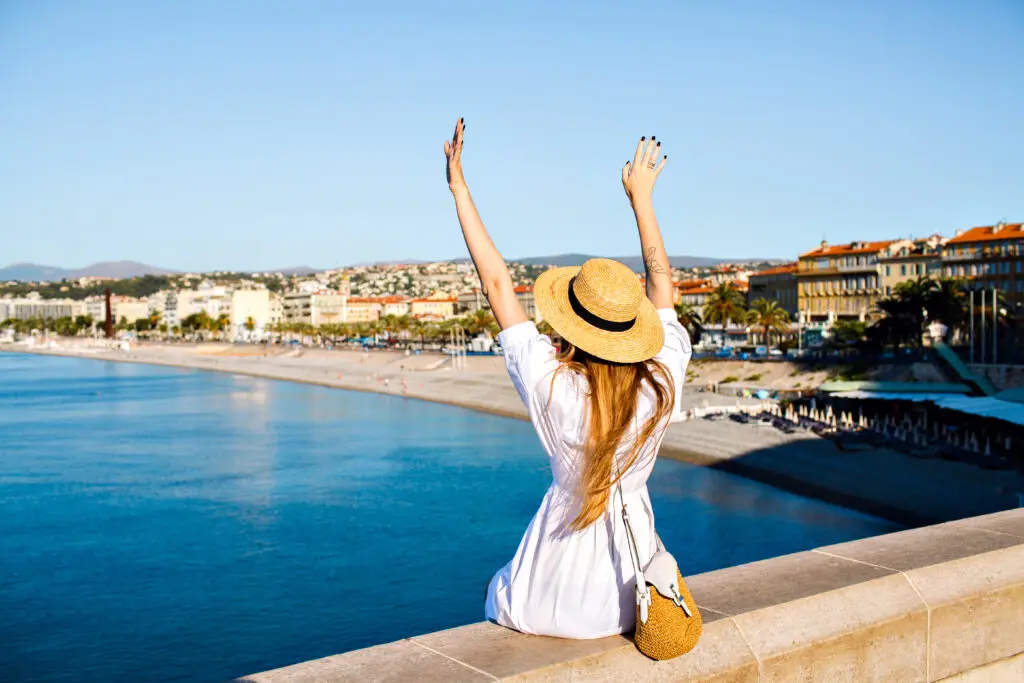 Woman enjoying the scenic view of the Promenade des Anglais and coastline in Nice France during a summer private tour