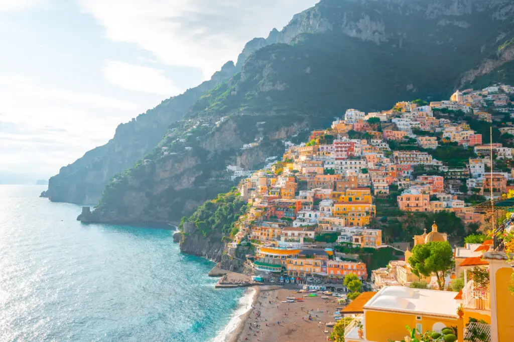 Colorful cliffside buildings overlooking the beach and turquoise sea in Positano on the Amalfi Coast, Italy, a popular European travel destination