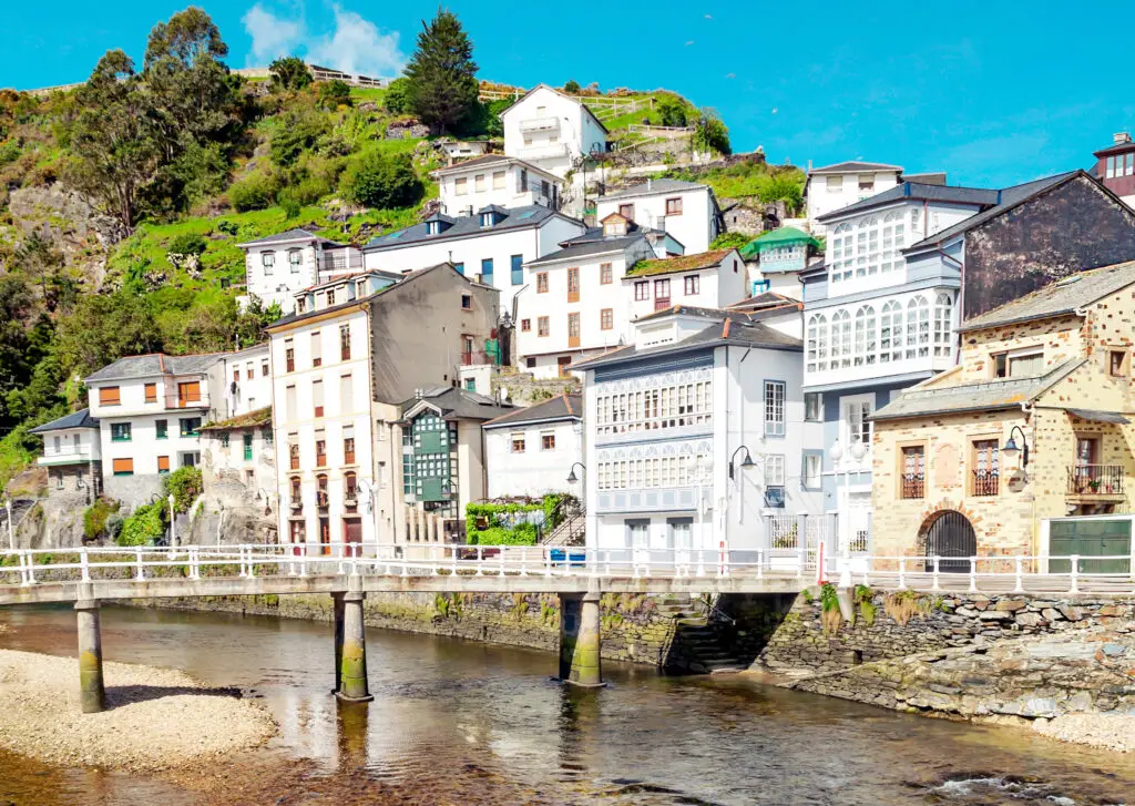 Colorful coastal houses and scenic riverfront in Luarca, Asturias, Spain, a picturesque seaside village popular for sightseeing and private tours in northern Spain
