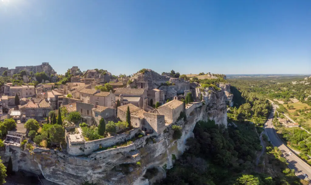 Aerial view of Les Baux-de-Provence village in southern France showcasing historic stone buildings, cliffs, and scenic countryside landscape