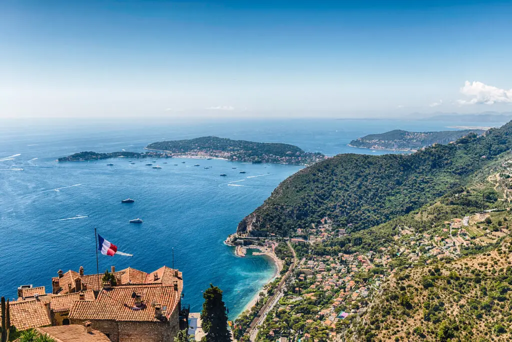 Panoramic view of Èze village on the French Riviera with terracotta rooftops, Mediterranean Sea, and coastline in southern France