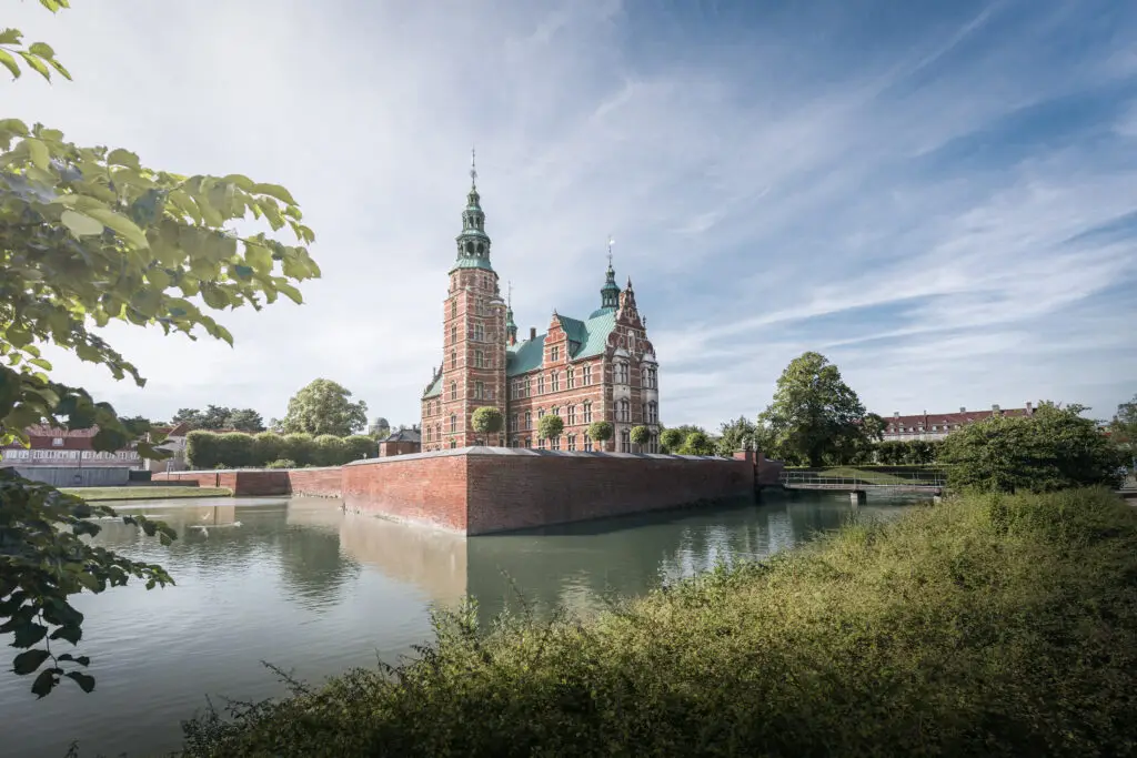 Rosenborg Castle in Copenhagen Denmark surrounded by a moat on a sunny day, popular tourist attraction and historic landmark in Scandinavia