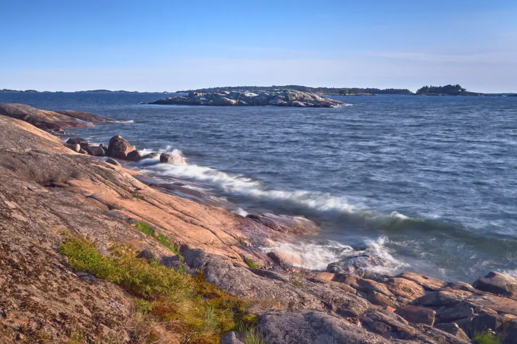 Rocky Baltic Sea coastline with waves and small islands at Porkkala, Finland, scenic coastal landscape for European nature tours