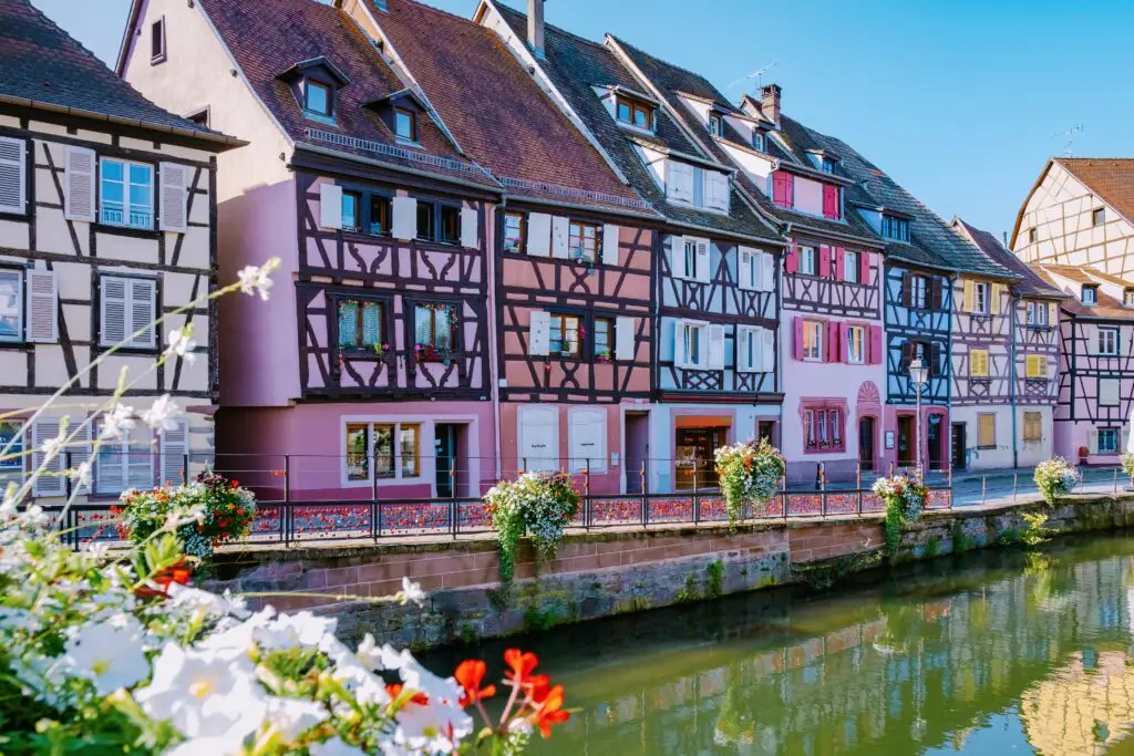 Colorful half-timbered houses along the canal in Colmar, France, a picturesque Alsace town known for its charming architecture and romantic European scenery