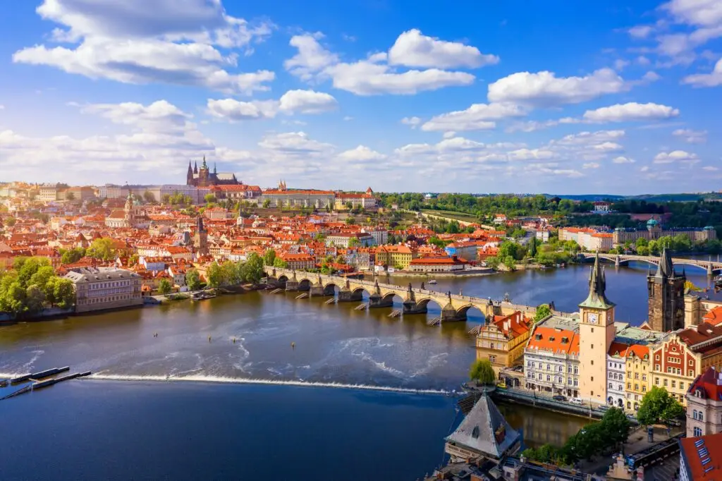 Scenic view of Prague Czech Republic with Charles Bridge over the Vltava River and Prague Castle in the background on a sunny day
