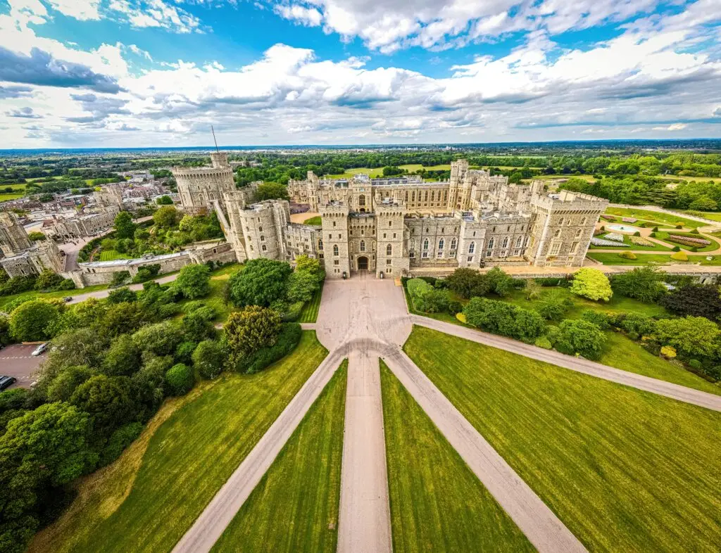 Aerial view of Windsor Castle in England, historic royal residence surrounded by gardens and greenery, popular tourist attraction in the United Kingdom