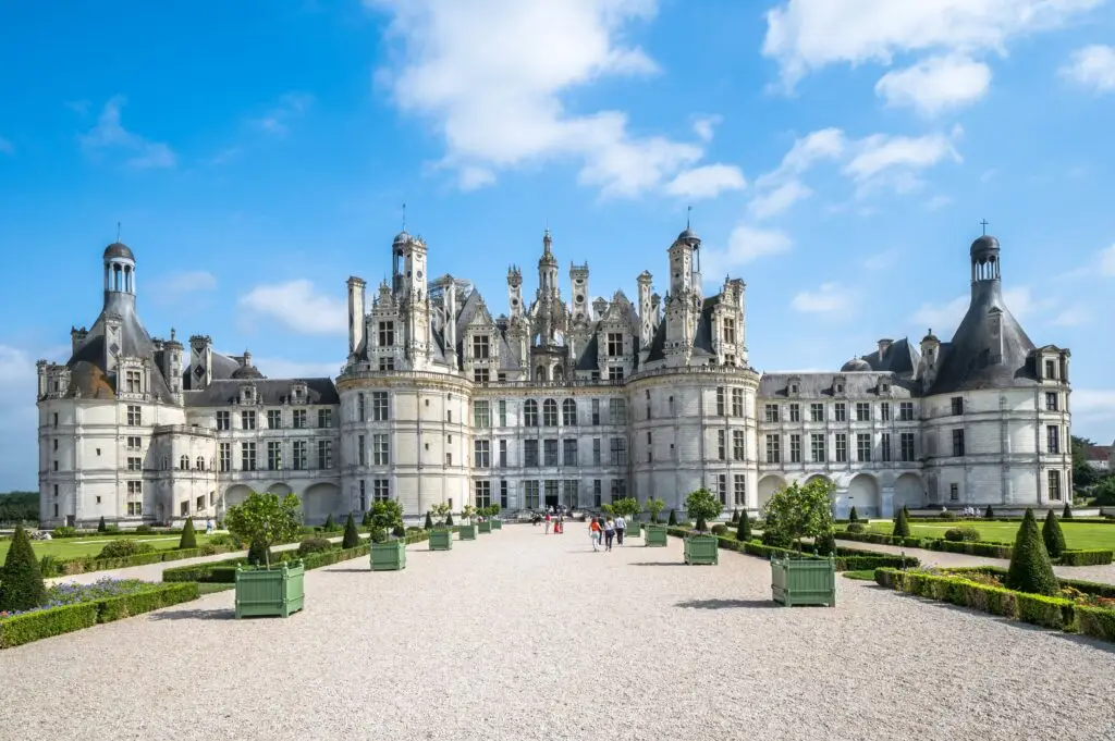 Château de Chambord in the Loire Valley, France, featuring Renaissance architecture and landscaped gardens under a bright blue sky