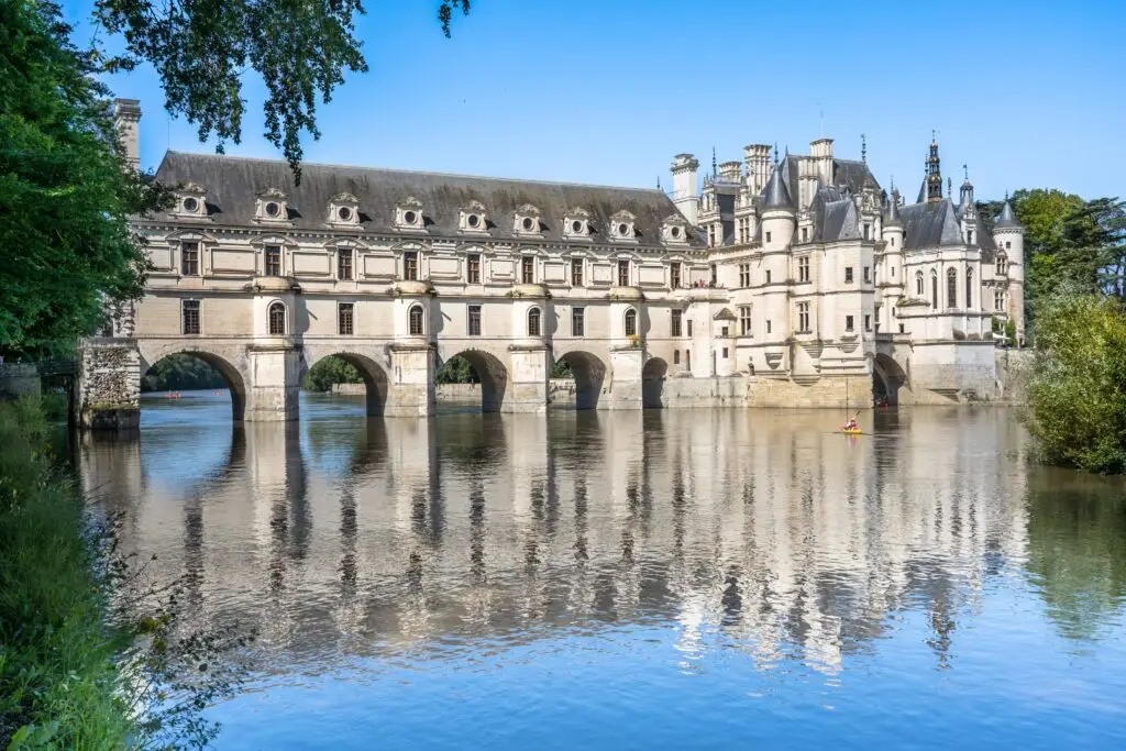Château de Chenonceau in the Loire Valley, France, reflected on the River Cher with its elegant arches and Renaissance architecture on a sunny day