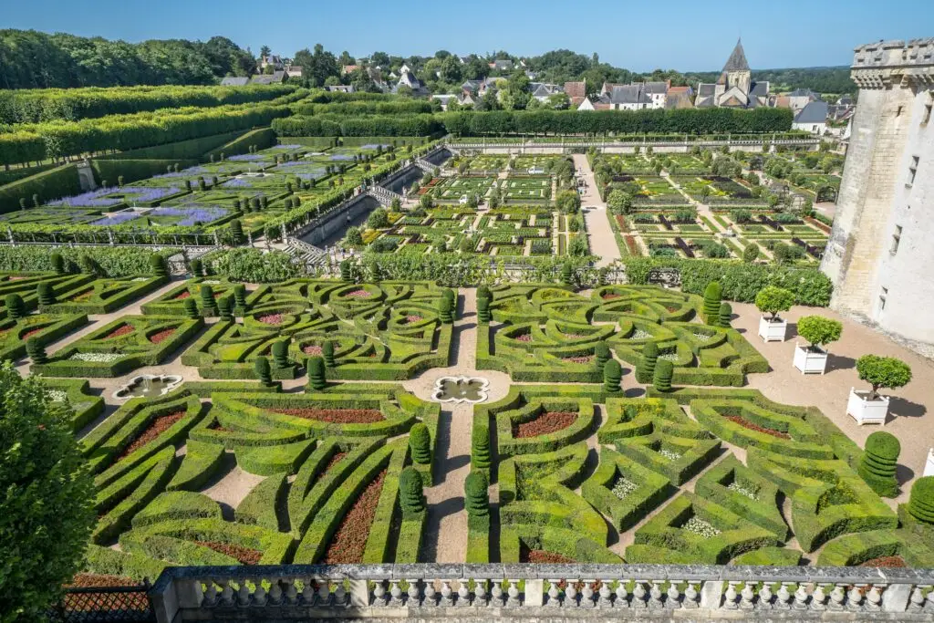 Beautifully landscaped Renaissance gardens at Château de Villandry in the Loire Valley, France, featuring intricate geometric hedges, colorful flower beds, and scenic views of the French countryside.