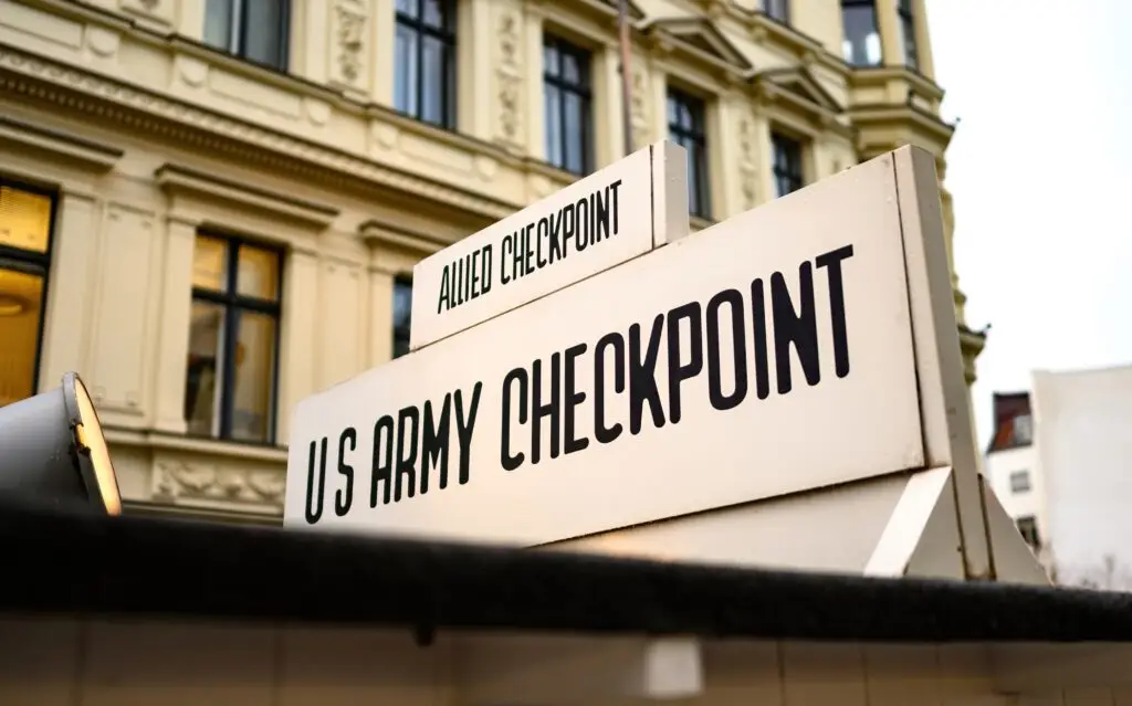 Historic Checkpoint Charlie sign at former U.S. Army border crossing in Berlin Germany, popular tourist attraction and Cold War landmark