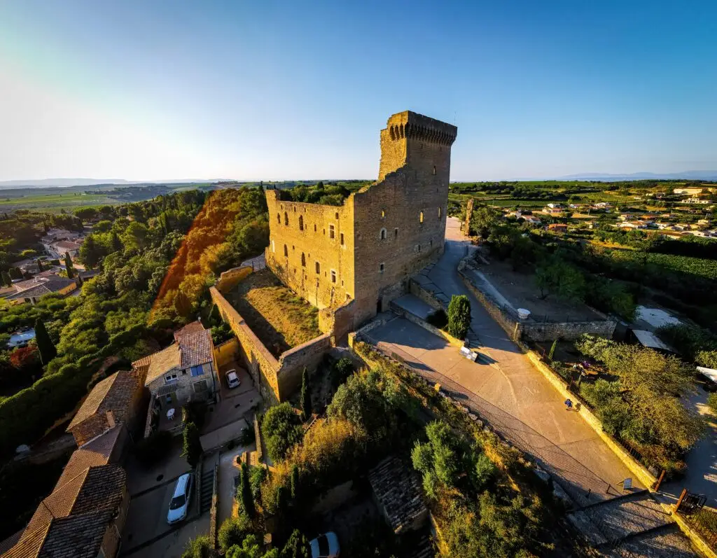 Aerial view of the historic Château de Châteauneuf-du-Pape surrounded by vineyards and village rooftops in Provence, France