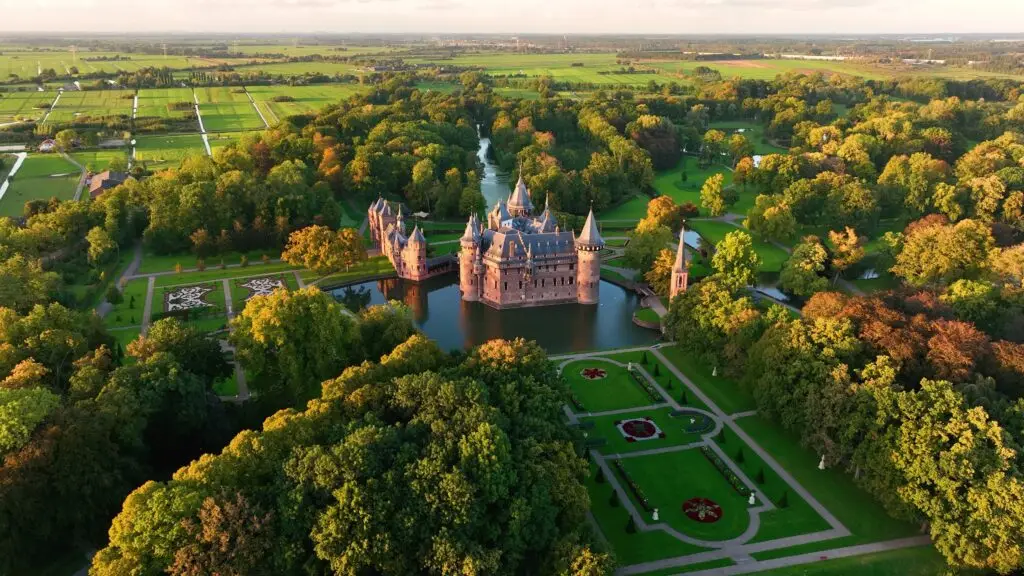 Aerial view of Kasteel De Haar castle surrounded by lush gardens and countryside near Utrecht, Netherlands, a popular tourist attraction for European private tours
