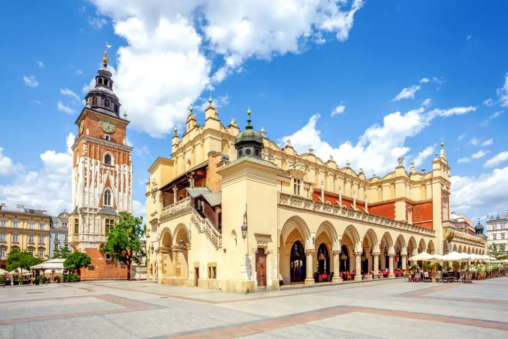 Cloth Hall and Town Hall Tower in the Main Market Square of Kraków, Poland on a sunny day, popular tourist attraction in the Old Town