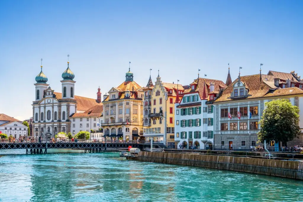 Scenic view of Lucerne old town and Jesuit Church along the Reuss River in Lucerne, Switzerland, popular destination for European private tours and sightseeing
