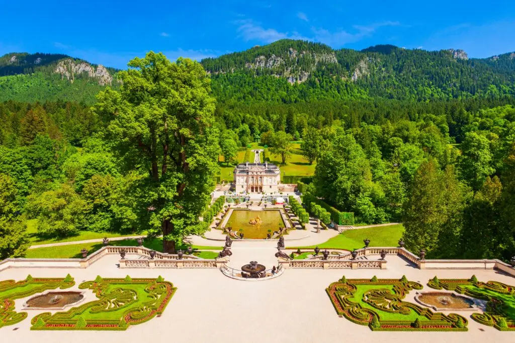 Linderhof Palace in Bavaria Germany surrounded by lush green gardens and mountains on a sunny day showcasing European architecture and landscape beauty