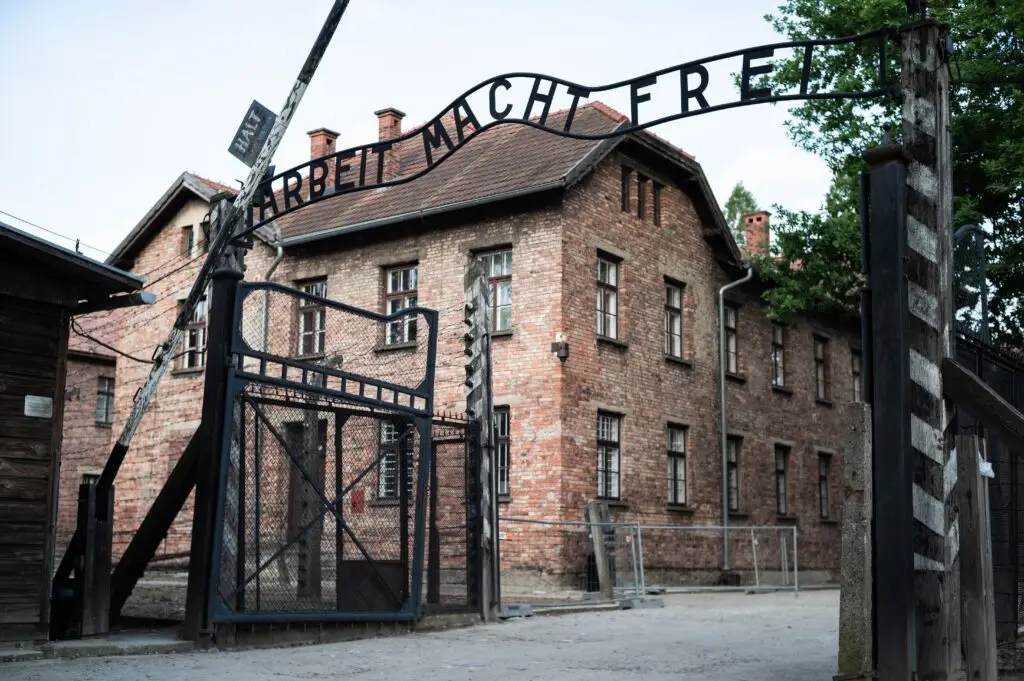 Entrance gate with the Arbeit Macht Frei sign at Auschwitz-Birkenau concentration camp in Oświęcim, Poland, a historic World War II memorial site and popular educational tour destination in Europe