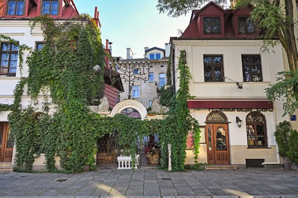 Historic ivy-covered building and restaurant entrance in the Jewish Quarter of Kazimierz, Krakow, Poland