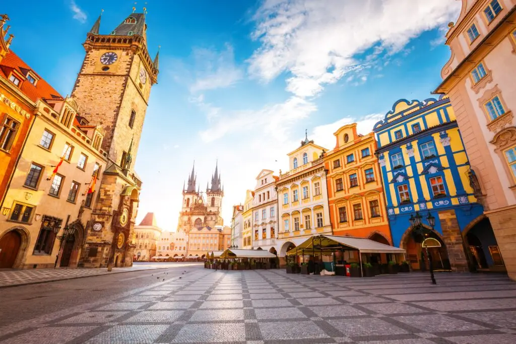 Prague Old Town Square with the Astronomical Clock and colorful historic buildings at sunrise, Czech Republic