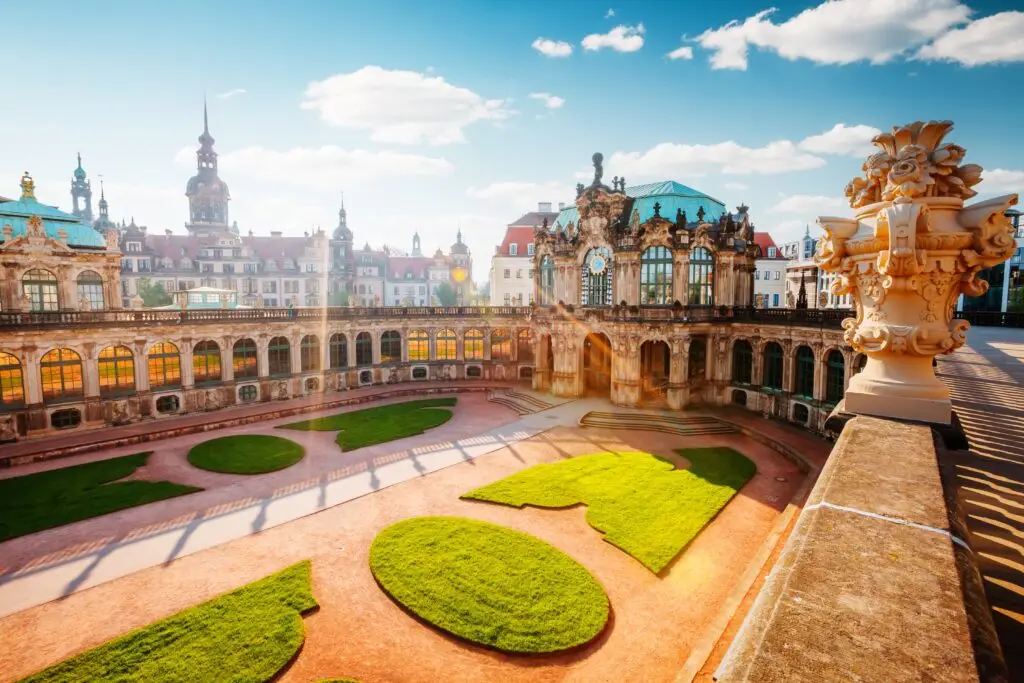Incredible view of the Zwinger Palace complex in Dresden, Germany, showcasing Baroque architecture and gardens under a bright blue sky