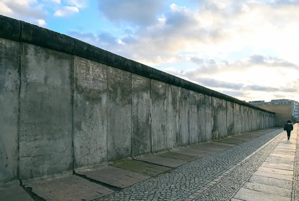 Berlin Wall historic site with pedestrian walkway at sunset in Berlin, Germany