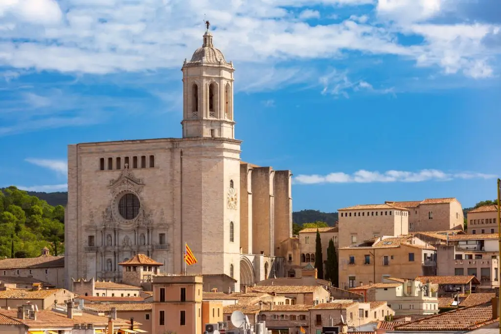 Girona Cathedral and historic old town under a bright blue sky in Girona, Spain, a popular sightseeing destination for European private tours