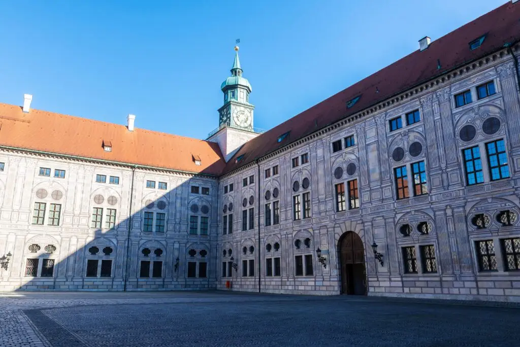 Munich Residenz Courtyard in Germany with Renaissance architecture and clock tower under clear blue sky