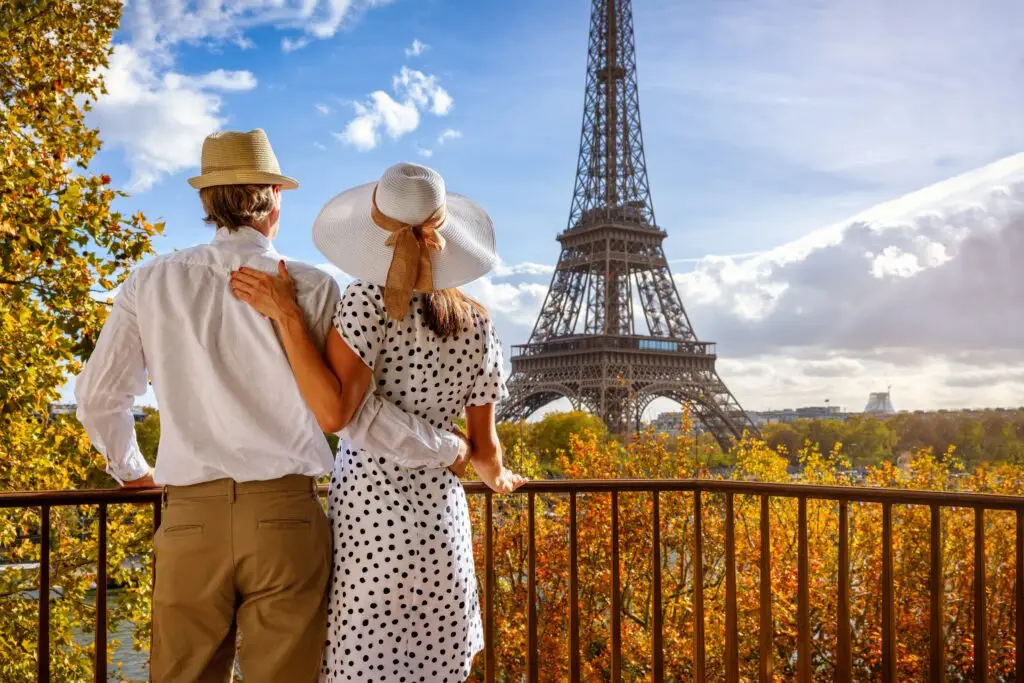 Romantic couple enjoying a scenic view of the Eiffel Tower in Paris France during an autumn city tour