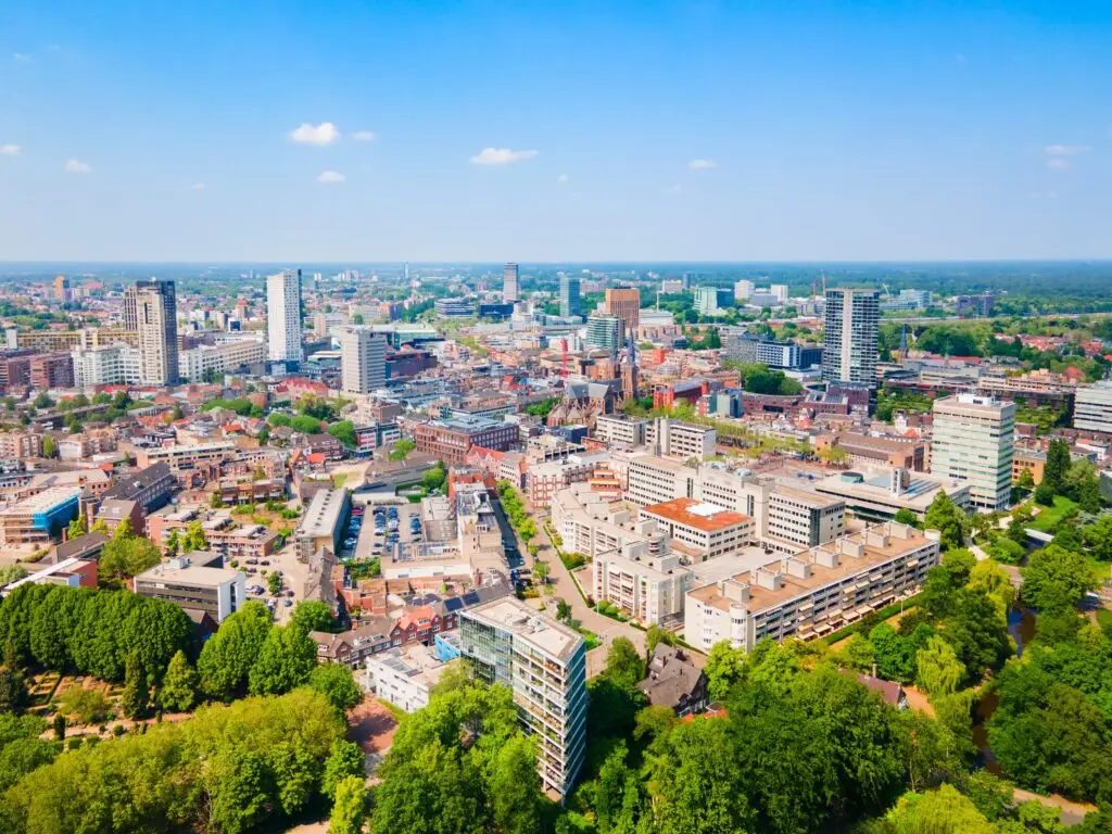 Aerial panoramic view of Eindhoven city skyline in the Netherlands with modern buildings, urban architecture, and green parks on a sunny day