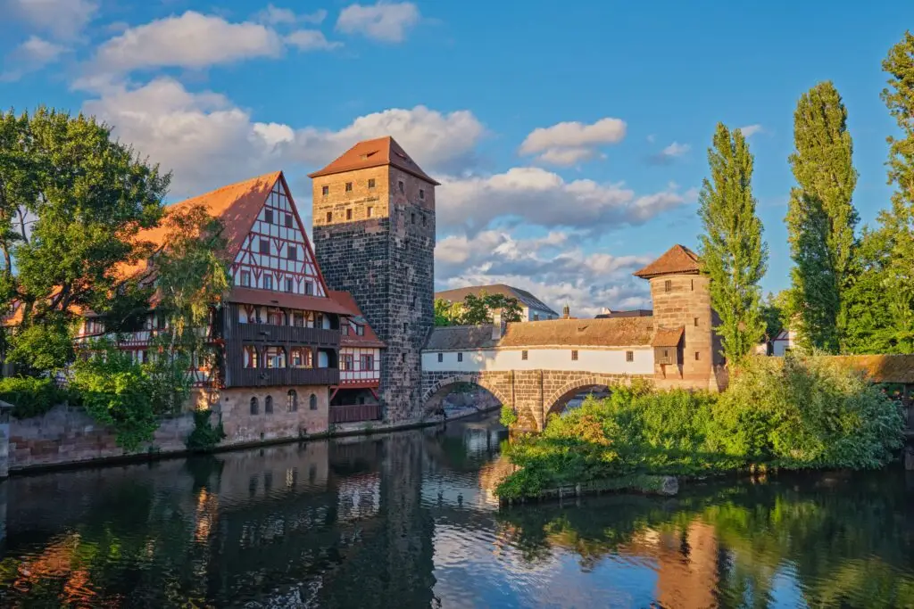 Historic medieval buildings and bridge over the Pegnitz River in Nuremberg, Germany, showcasing traditional Bavarian architecture and scenic old town views for Europe Private Tours